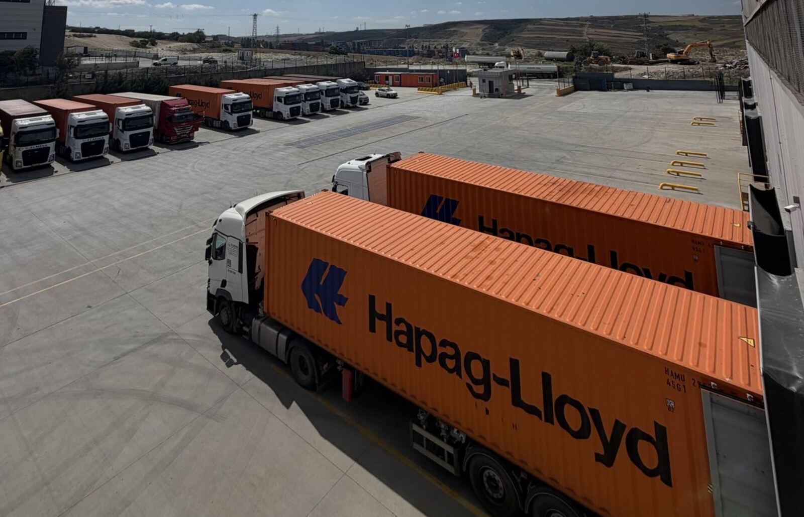 Trucks carrying containers in the yard